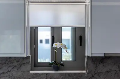a window with a vase with a flower in it at Demiani House in Lardos