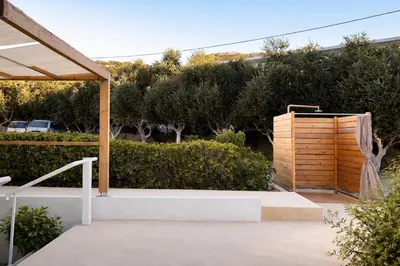 a patio with a wooden fence and a wooden box at ANGELOS STUDIOS 1-2 in Faliraki Rhodes-Ground Floor in Faliraki