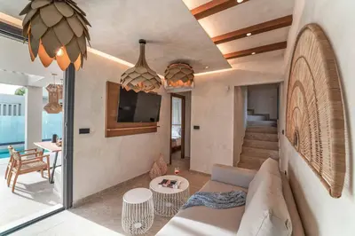 a living room with a couch and a table at Villa Helios in Kiotari