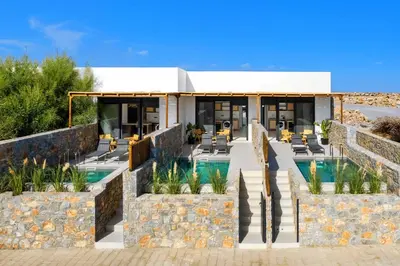 a resort with a swimming pool and a building at Villa Kiotari Sky in Kiotari