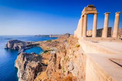 a temple on a cliff next to the ocean at Lindos Tsambika Studios in Líndos