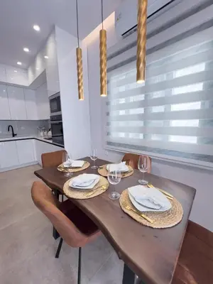 a dining room with a wooden table and chairs at AleNi City Apartment 1 in Rhodes Town