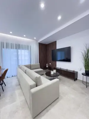 a living room with a couch and a flat screen tv at AleNi City Apartment 1 in Rhodes Town
