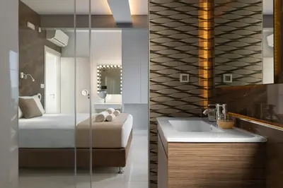 a bathroom with a bed and a sink and a mirror at Rhodes Skyline Suite with out Door Jacuzzi Sea View A2 in Ixia