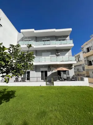 a building with a lawn in front of it at Kyra Maria in Rhodes Town