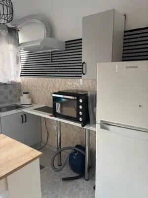 a kitchen with a counter with a microwave and a refrigerator at Rosi Rhodos in Rhodes Town