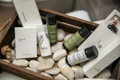 a wooden box filled with spa products and rocks at Kiki Luxury Villa in Afantou
