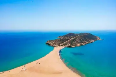 an island in the ocean with people on a beach at Villa Athena Classico in Kolimbia