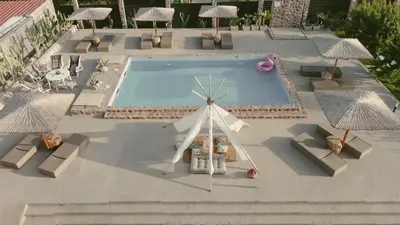 a model of a windmill and a pool with umbrellas at LA Casa Di Lusso Casa N2 Adults Only in Kolimbia