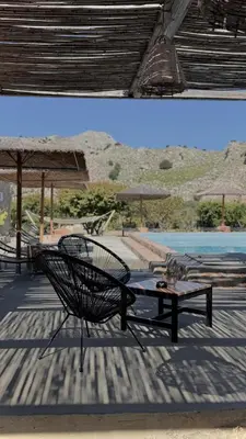 a patio with a bench and a table and a pool at LA Casa Di Lusso Casa N2 Adults Only in Kolimbia
