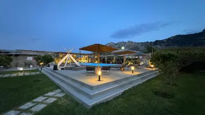 a patio with a table and chairs and a pool at LA Casa Di Lusso Casa N2 Adults Only in Kolimbia