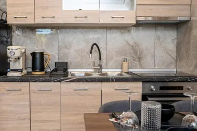 a kitchen with wooden cabinets and a sink at Hera Elysium Retreat Villas in Kalavárda