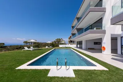 a swimming pool in front of a building at Aquarama Pool Apt - Orion in Ixia