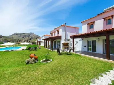 a backyard of a house with a pool at Holiday Home Haus in Kolympia mit Garten und Bergblick by Interhome in Kolimbia