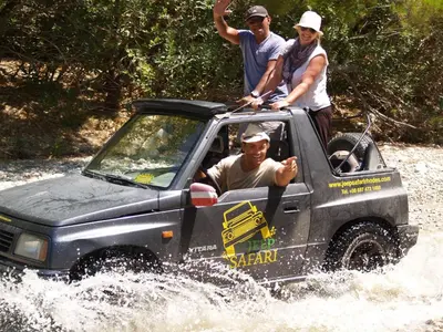 a group of people in a jeep in the water at Holiday Home Haus in Kolympia mit Garten und Bergblick by Interhome in Kolimbia