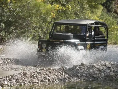 a jeep driving through the water on a river at Holiday Home Haus in Kolympia mit Parkplatz und Bergblick by Interhome in Kolimbia