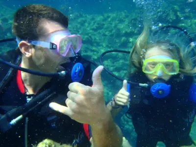 a man and woman giving thumbs up while scuba diving at Holiday Home Haus in Kolympia mit Parkplatz und Bergblick by Interhome in Kolimbia