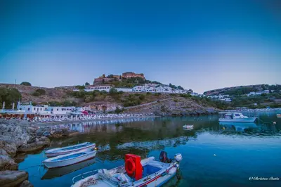 a group of boats docked in a body of water at Lindos Shore Superior Studio in Líndos