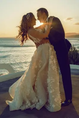 a bride and groom standing on the beach at Axiotheaton Villas in Pefki Rhodes