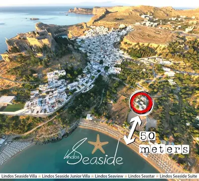 an aerial view of a harbor with a house and the ocean at Lindos SeaStar Apartment in Líndos