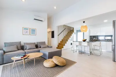 a living room with a couch and a table at Villa Serene with swimming pool in Lindos in Líndos