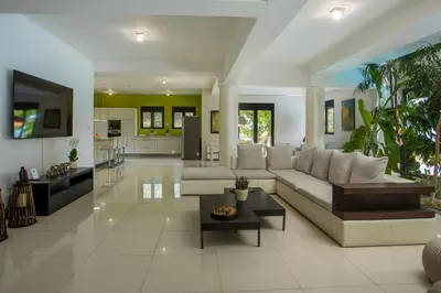 a living room with a couch and a table at Villa Melia in Koskinou