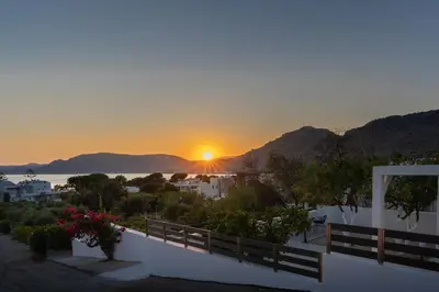 a sunset from a house with a view of the ocean at George Beach Studios in Pefki Rhodes