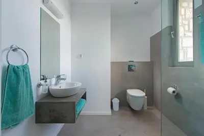 a white bathroom with a sink and a toilet at Luxury Villa Hera with Private Pool in Afantou
