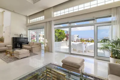 a living room filled with furniture and a large window at City Mansion Rhodes in Rhodes Town