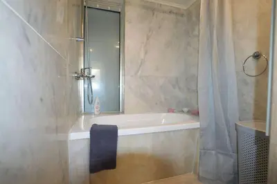 a bathroom with a bath tub with a shower curtain at Renes Paradise Seahome - Afandou Beach, Rhodes in Rhodes Town