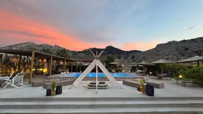 a resort with a swimming pool with mountains in the background at LA Casa Di Lusso Grande Casa -Adults Only in Kolimbia