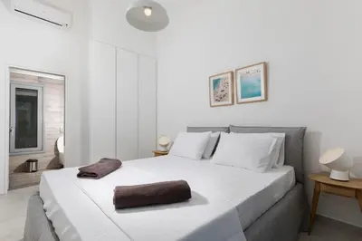 a bedroom with a white bed with a brown towel on it at Villa Phos with swimming pool in Lindos in Líndos