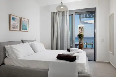 a bedroom with a bed and a view of the ocean at Villa Phos with swimming pool in Lindos in Líndos