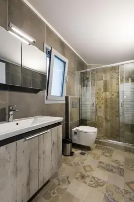 a bathroom with a sink and a toilet at Villa Phos with swimming pool in Lindos in Líndos