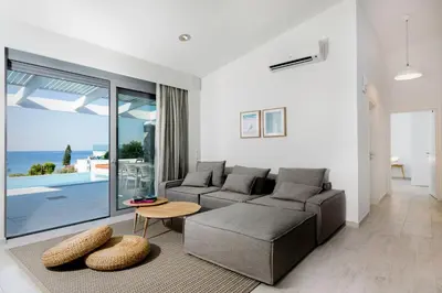 a living room with a couch and a table at Villa Crystal with swimming pool in Lindos in Líndos