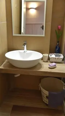 a bathroom with a white sink and a mirror at Niochori apartments 3 in Rhodes Town