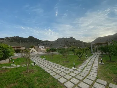 a walkway in a park with mountains in the background at LA Casa Di Lusso N5 - Adults Only in Kolimbia