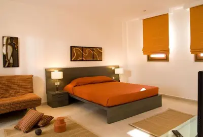 a bedroom with a bed and a chair and a couch at Executive Rhodes Villa 4 Bedroom 4 Bathroom Bd Villa Pefkos in Pefki Rhodes