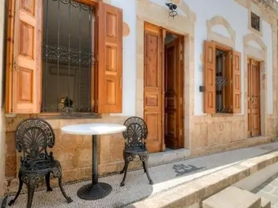 a table and two chairs in front of a building at Deluxe Rhodes Villa Villa Sokaki Well Furnished 2 Bedrooms in Líndos