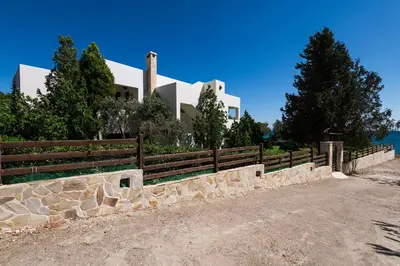 a house with a fence in front of it at Emerald Dawn Villa in Pefki Rhodes