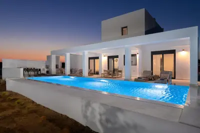 a villa with a swimming pool at night at Seacarf Villa, 3 magnificent properties in Lachania beach, Bedrooms 12, Sleeps 27 in Lachania