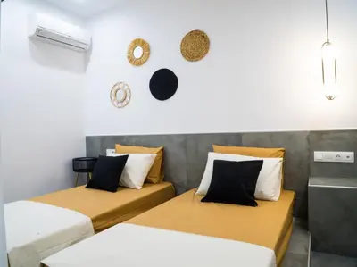 a room with two beds and a wall at Orama in Faliraki