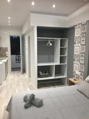 a bedroom with a bed with shoes on it at RHODIAN TREASURE Spiridione apartment in Rhodes Town