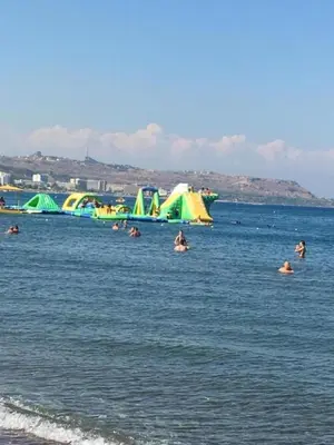 a group of people in the water at the beach at RHODIAN TREASURE Spiridione apartment in Rhodes Town