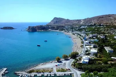 a view of a beach with boats in the water at Stegna Sunny Beach- up floor in Archangelos