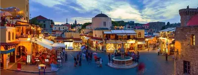 a group of people walking around a city street at Ossiano Pool Villas,Heating Pool, 2 min drive to Haraki Beach & 10 min to Lindos in Haraki