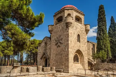 an old stone church with a red roof at Villa Paleos Evergreen by Villa Plus in Ialyssos