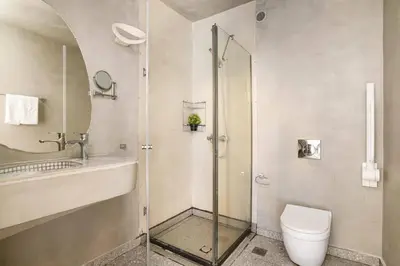 a bathroom with a shower and a toilet and a sink at Villa Alcyone Seastone by Villa Plus in Kiotari