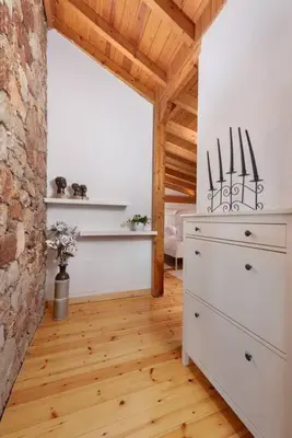a room with a chest of drawers and a brick wall at AGROLUX OASIS - A Private Pool Escape in Lush Agricultural Serenity in Sálakos