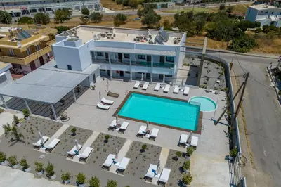 an aerial view of a building with a swimming pool at Kellys Luxury Apartments in Faliraki
